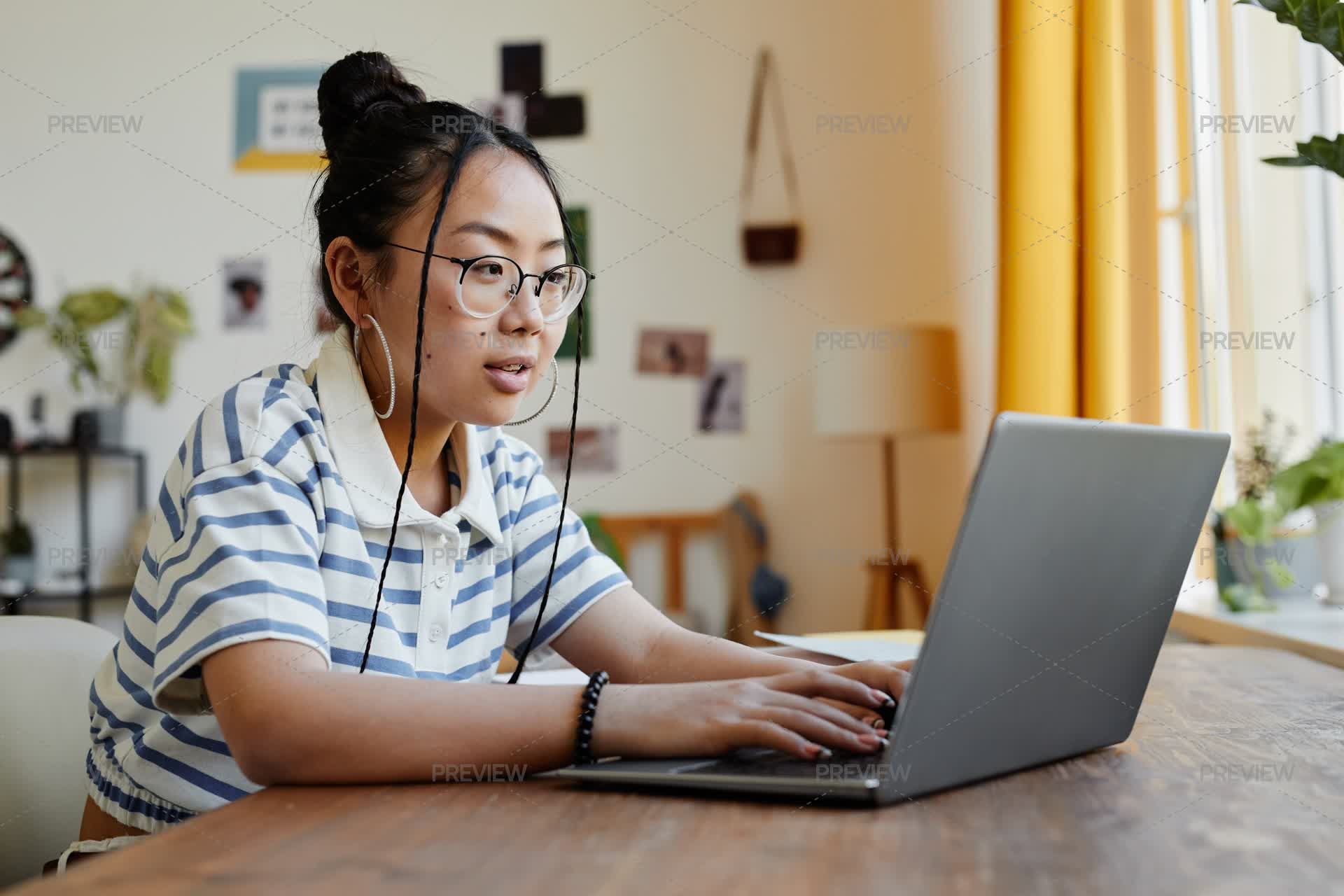 Teenage Girl Using Laptop Side View - Stock Photos | Motion Array