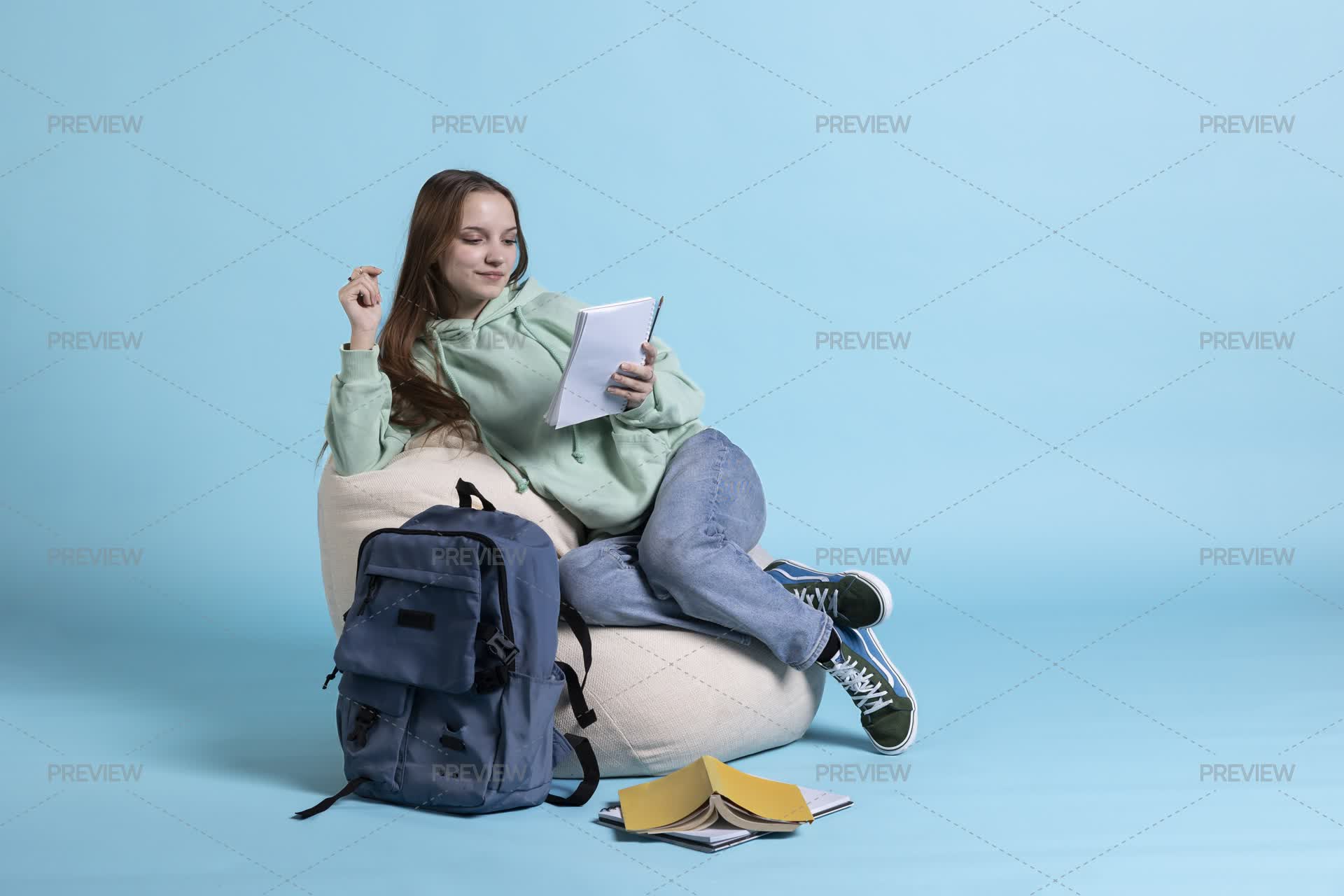 Smiling Person With Notepad In Arms Reading High School Classes Notes ...