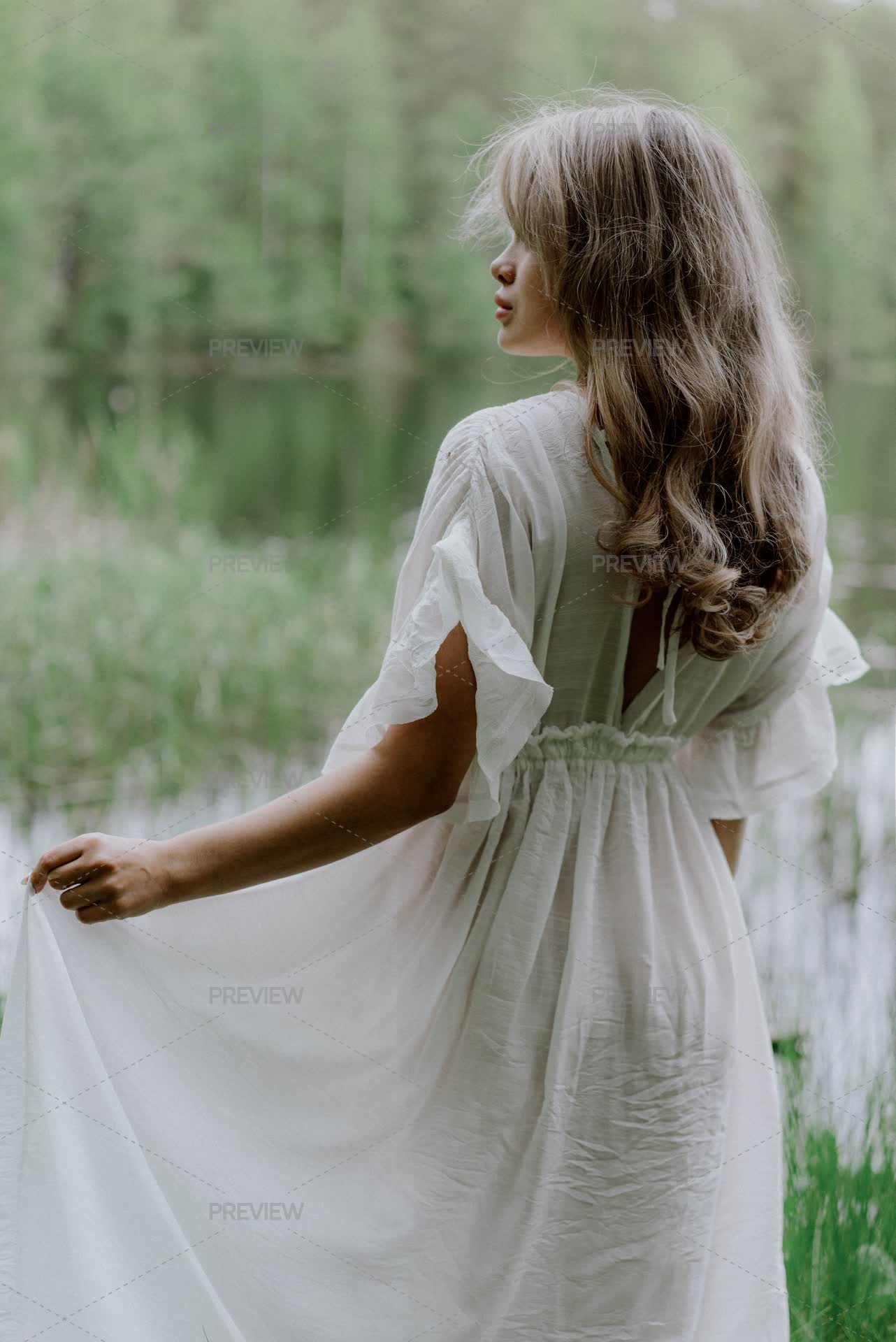 Woman Wearing A White Transparent See-Through Long Dress And Standing In Water by lponline - Stock Photos | Motion Array Woman Wearing A White Transparent See-Through Long Dress And Standing In Water by lponline - Stock Photos | Motion Array