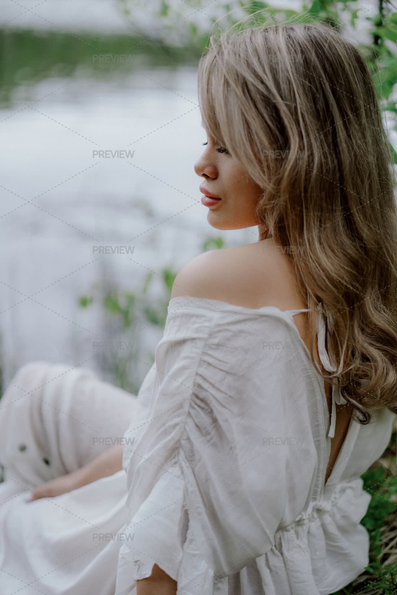 Woman In A White Dress Near A Body Of Water In A Forest by lponline - Stock Photos | Motion Array Woman In A White Dress Near A Body Of Water In A Forest by lponline - Stock Photos | Motion Array