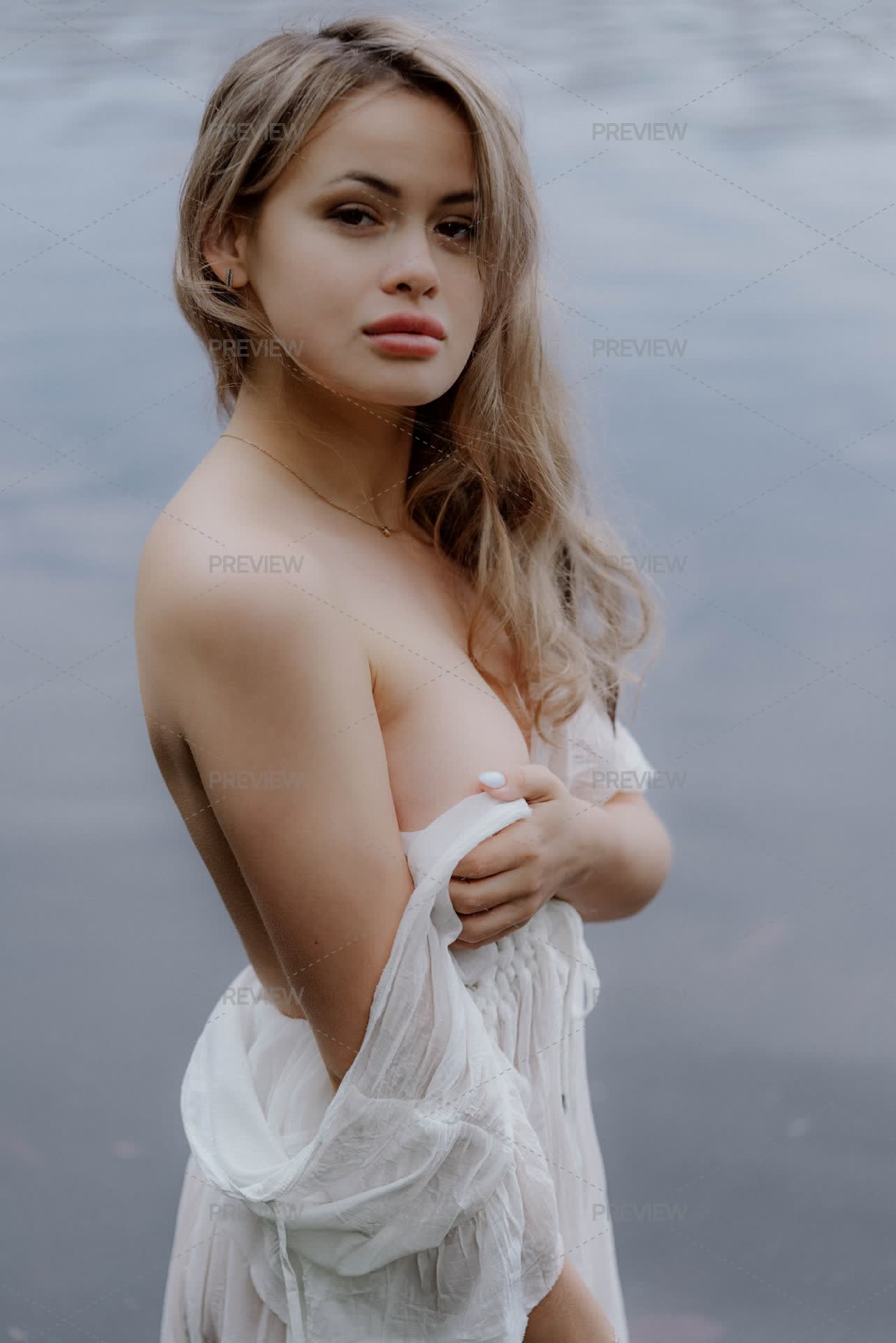 Woman Wearing A White See-Through Long Dress And Standing In The Water by lponline - Stock Photos | Motion Array Woman Wearing A White See-Through Long Dress And Standing In The Water by lponline - Stock Photos | Motion Array
