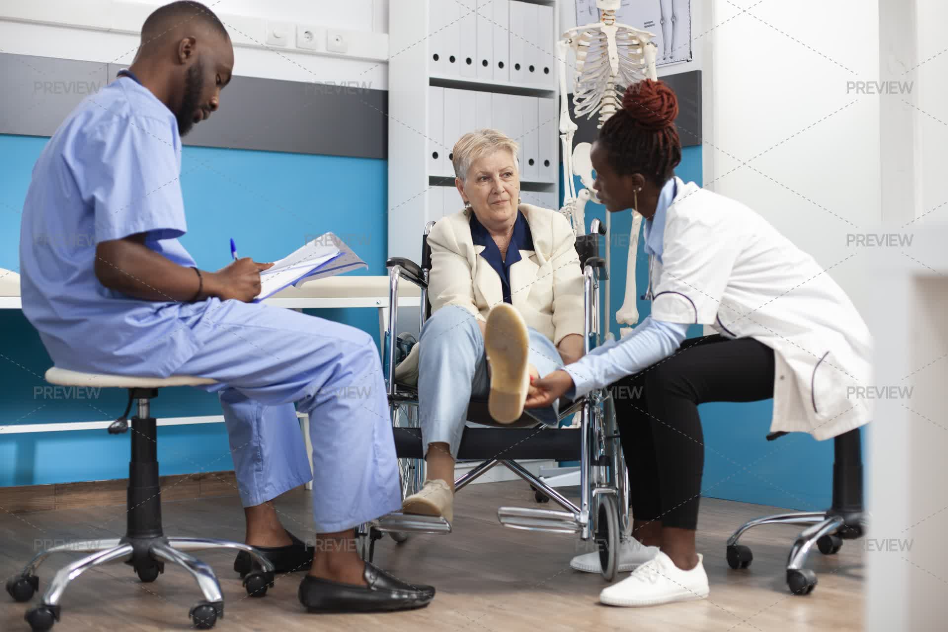 Caring For Users Medical Team Caring For A Wheelchair User - Stock Photos | Motion Array