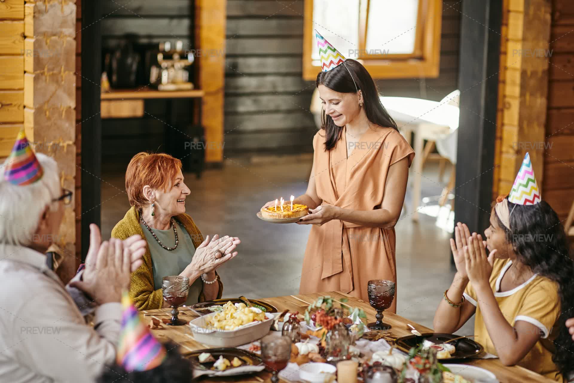 Clapping Cake Family Clapping Hands While Young Woman Carrying Birthday Cake by ...