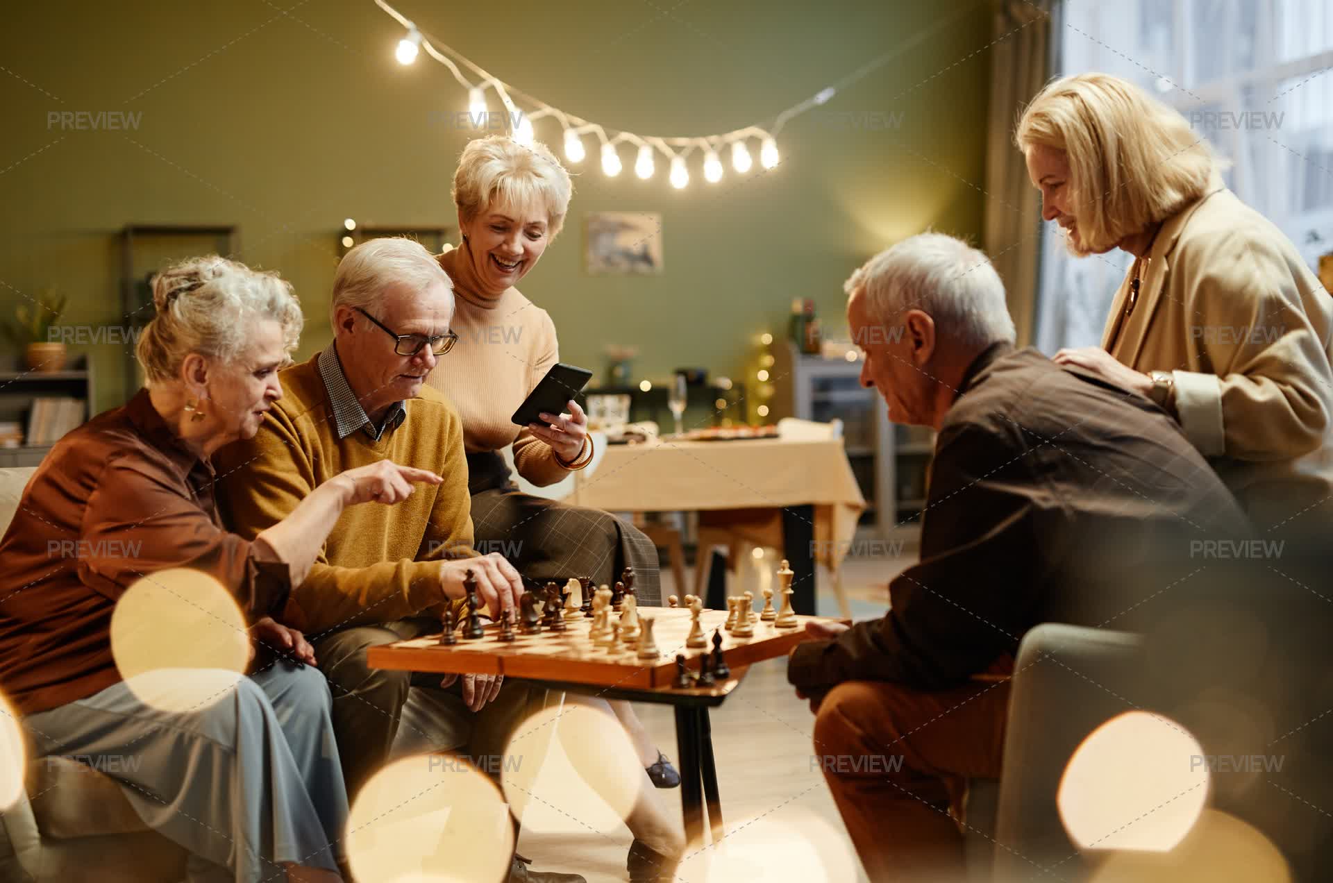 Senior Chess Group Of Seniors Playing Chess At Home - Stock Photos | Motion Array