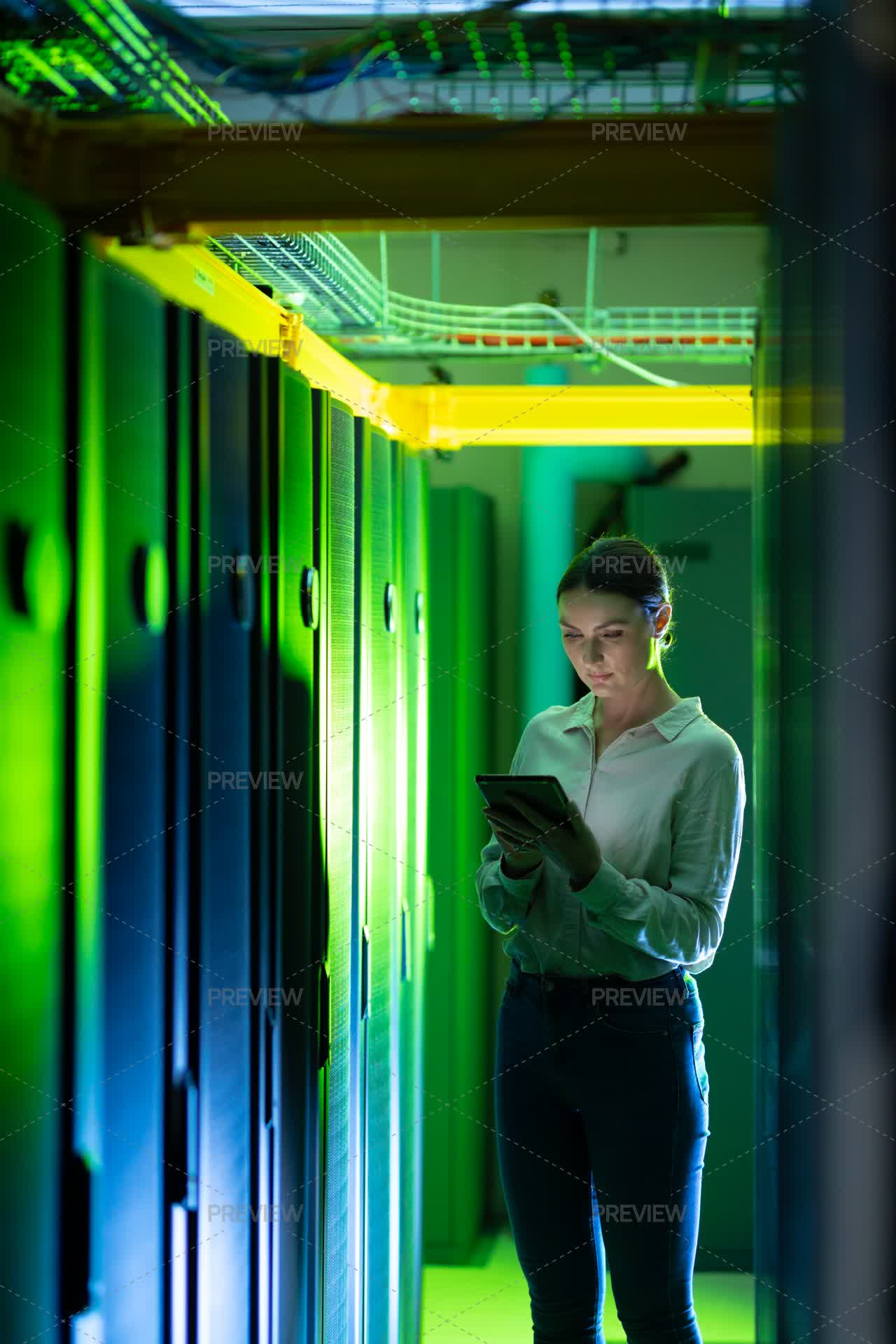 Woman In Data Center Using A Tablet - Stock Photos | Motion Array