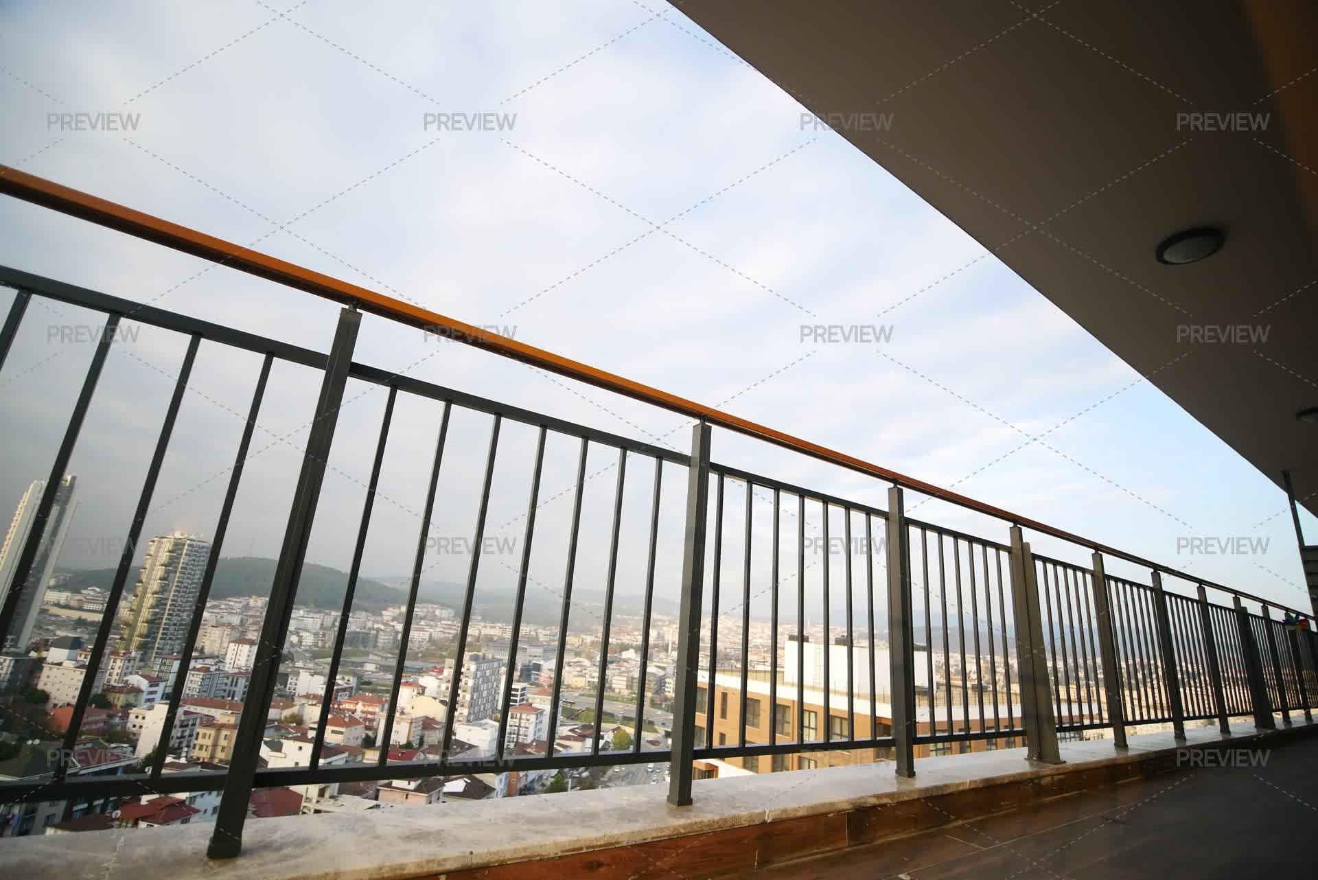 Balcony View Frame Balcony Railing Frames A Panoramic View Of A Bustling City Skyline. by ...