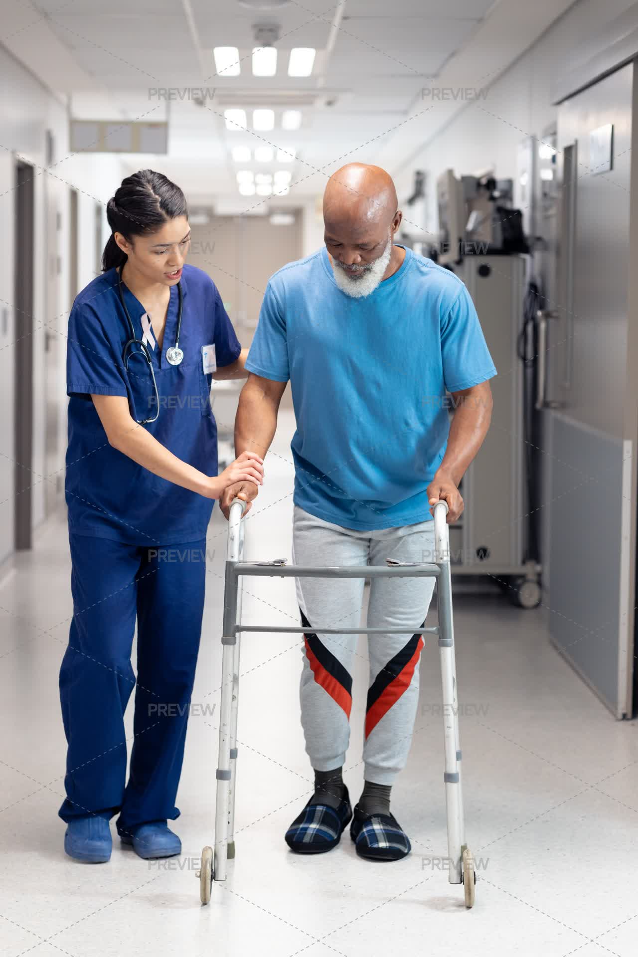Snurse Using Walker Nurse Assisting Elderly Patient Use Walker by Wavebreak Media - Stock ...