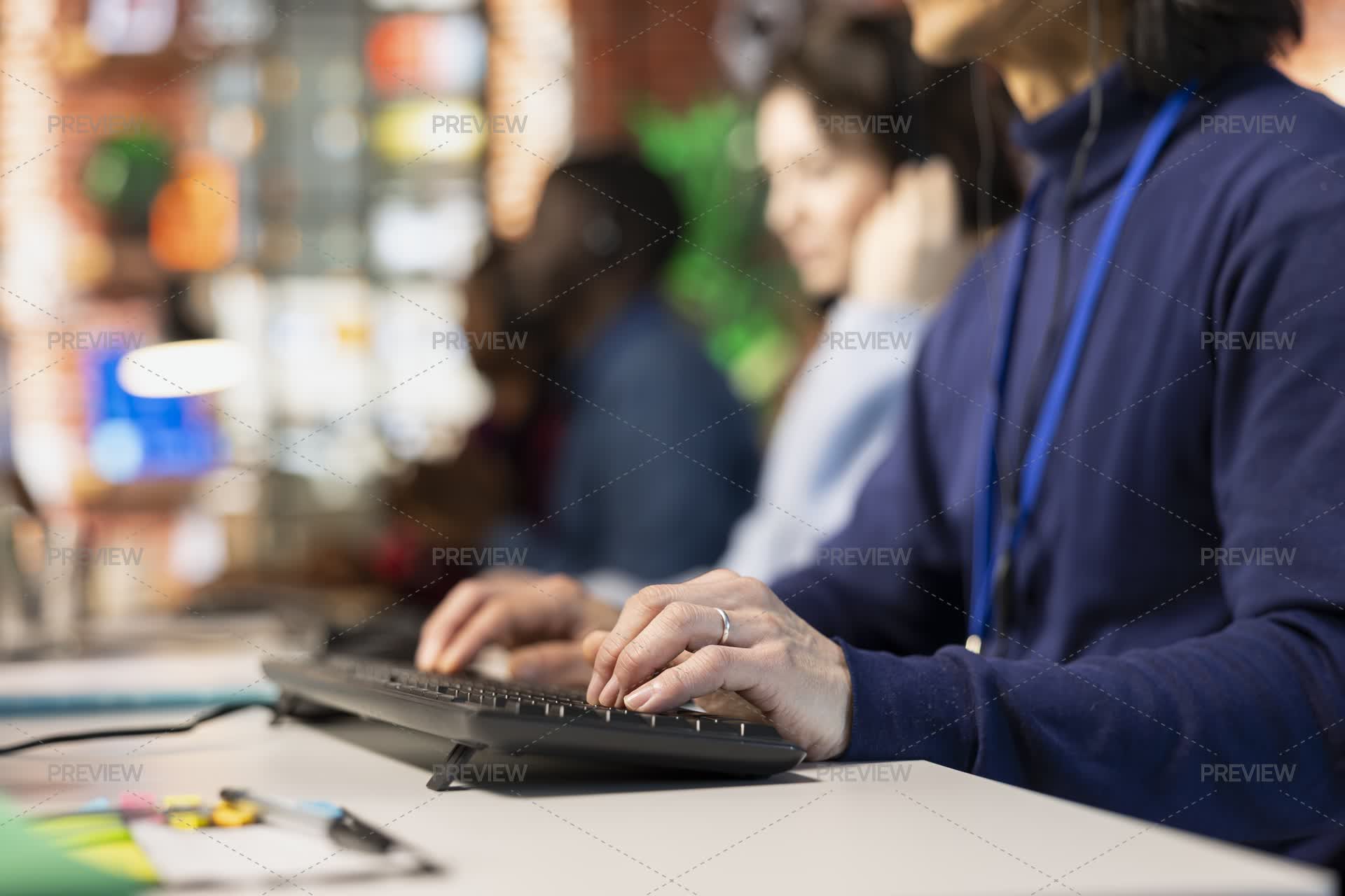 Call Center Staff Member Typing On Keyboard, Providing Step By Step ...