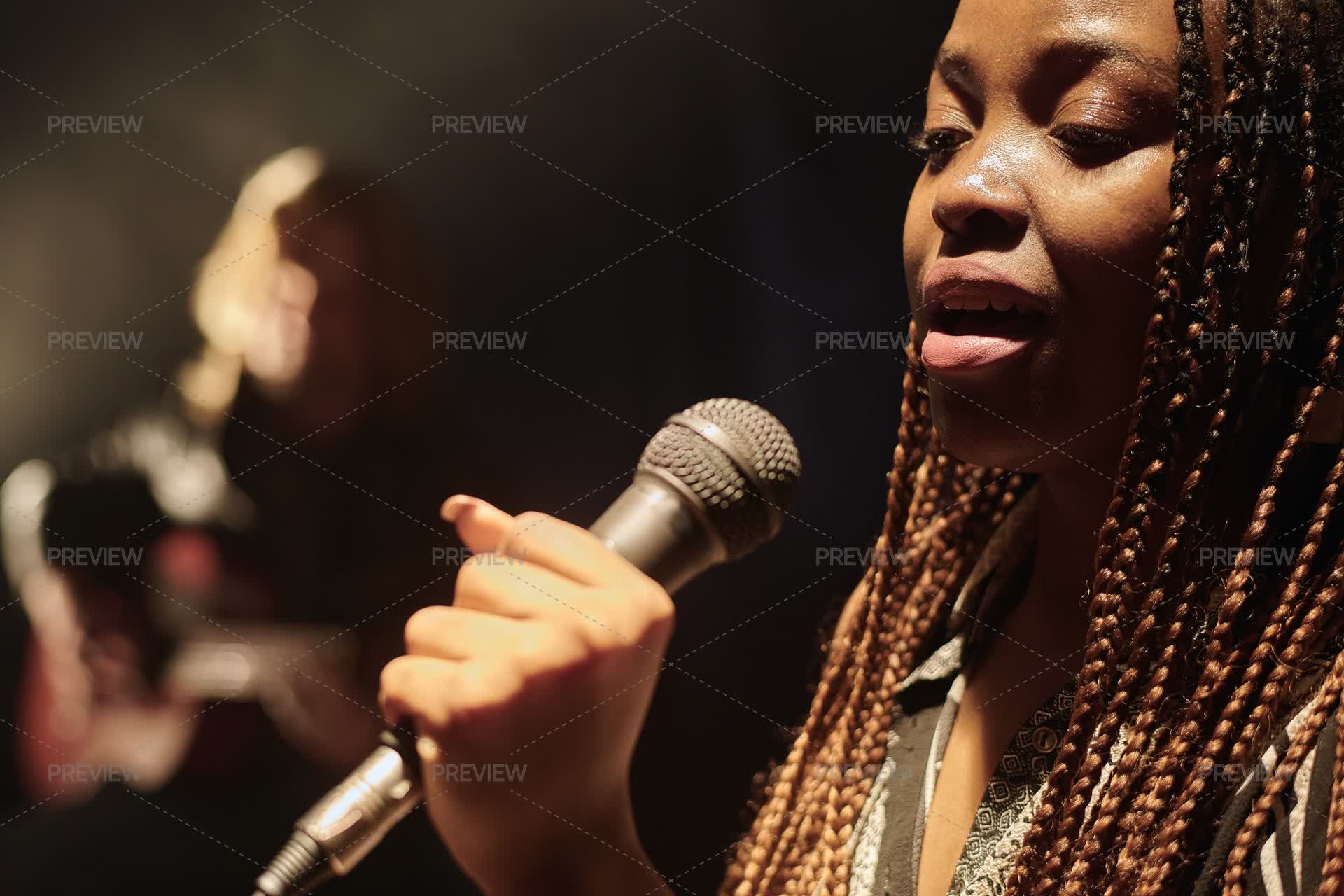 Singer Holding Microphone And On Stage In The Spotlight - Stock Photos ...