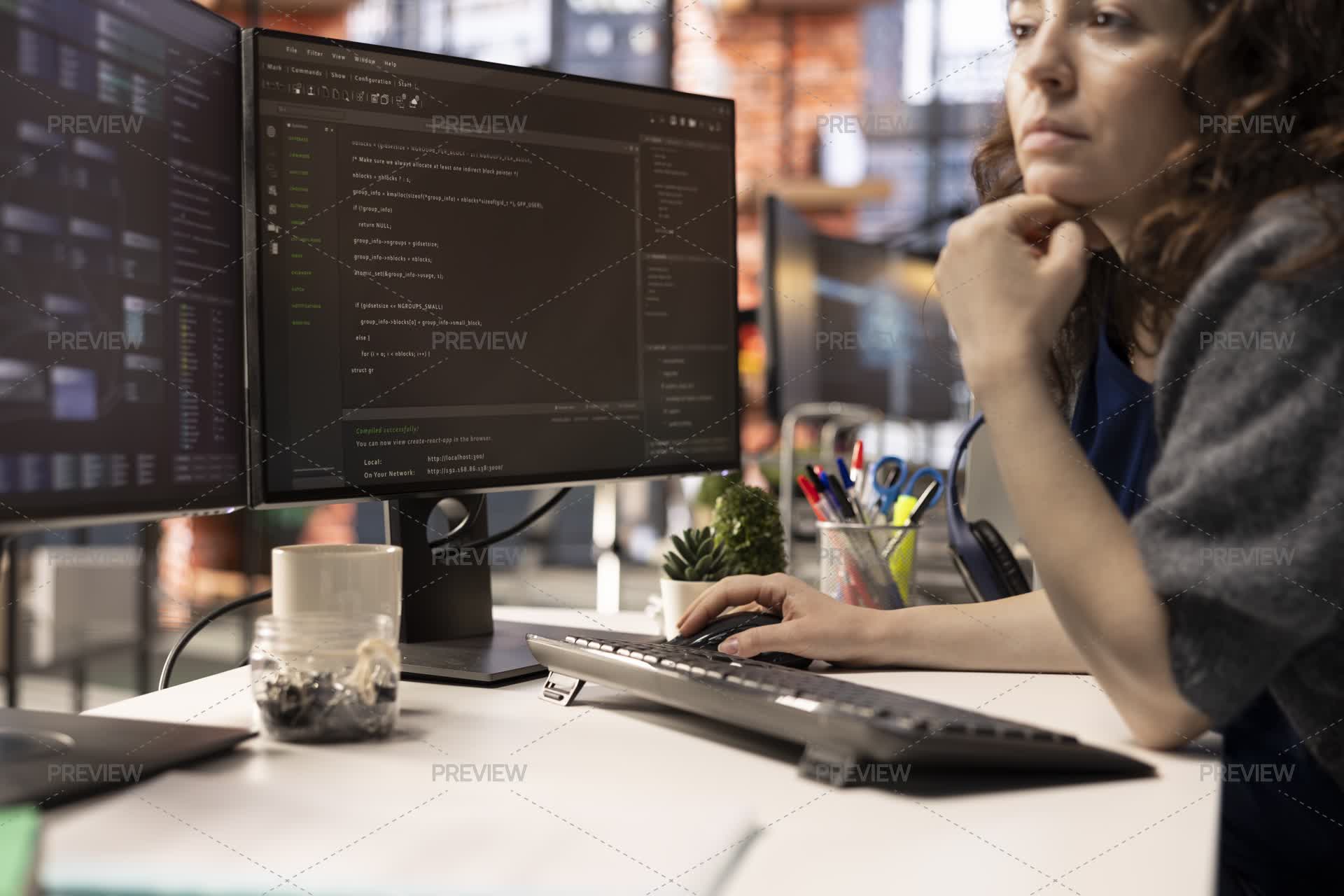 Female Programmer Seen Typing Code For A User Interface Design On Dual ...