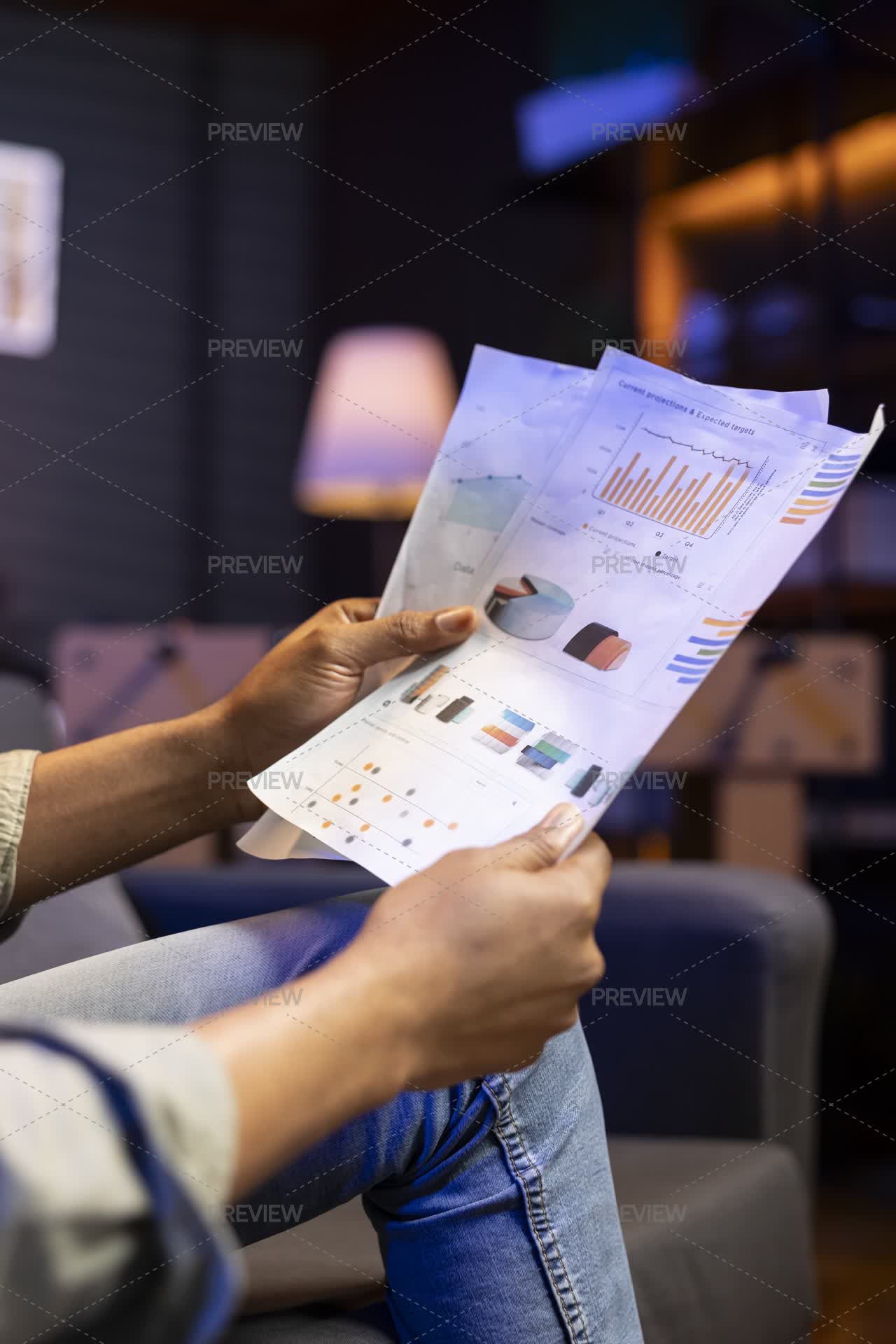 Man Sitting On The Sofa And Reading Research Papers With Analytics ...