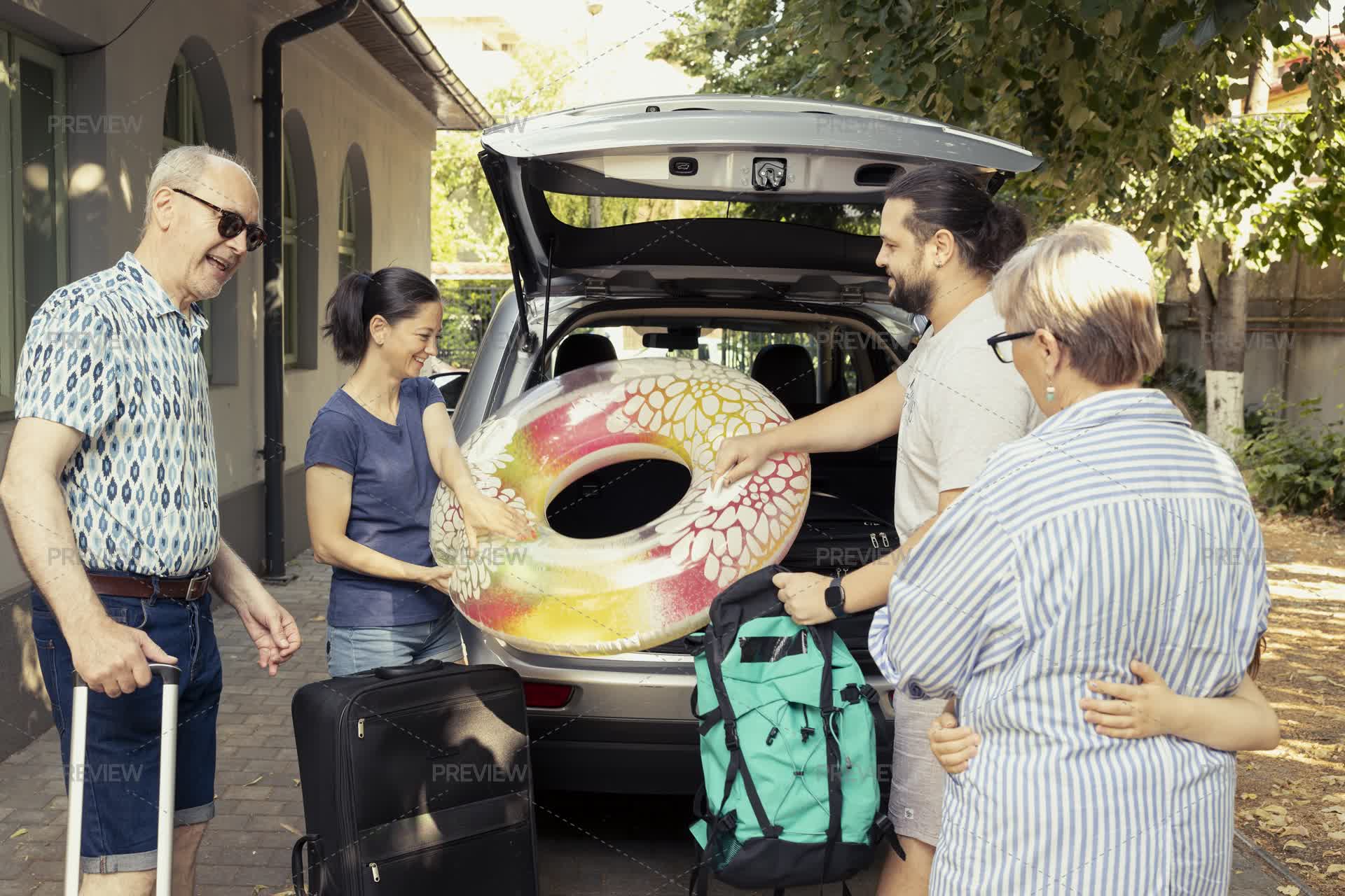 Multi-Generational Family Shares A Cheerful Car Packing Activity Before ...