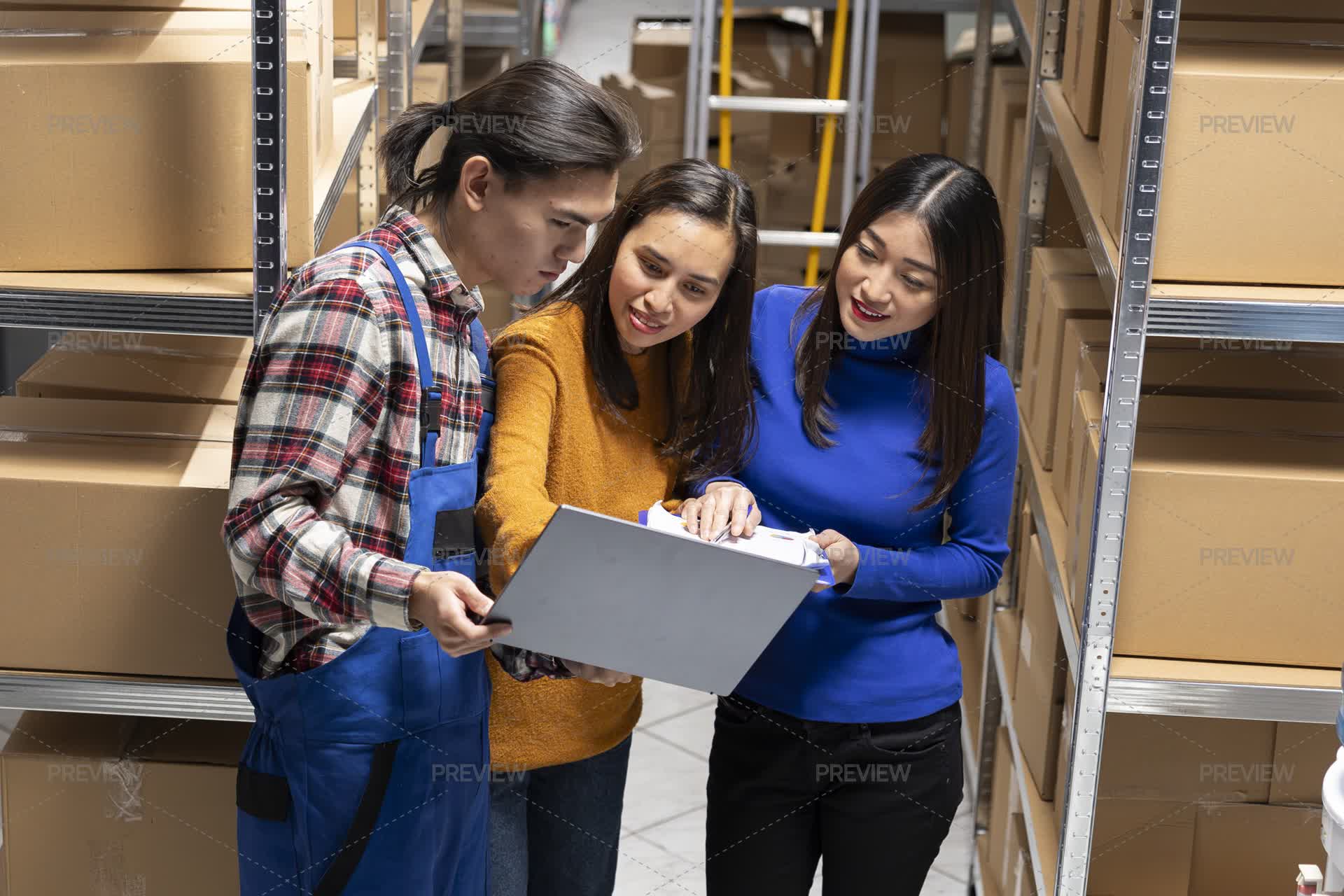 Staff Members Working In A Small Storehouse To Organize Packages ...