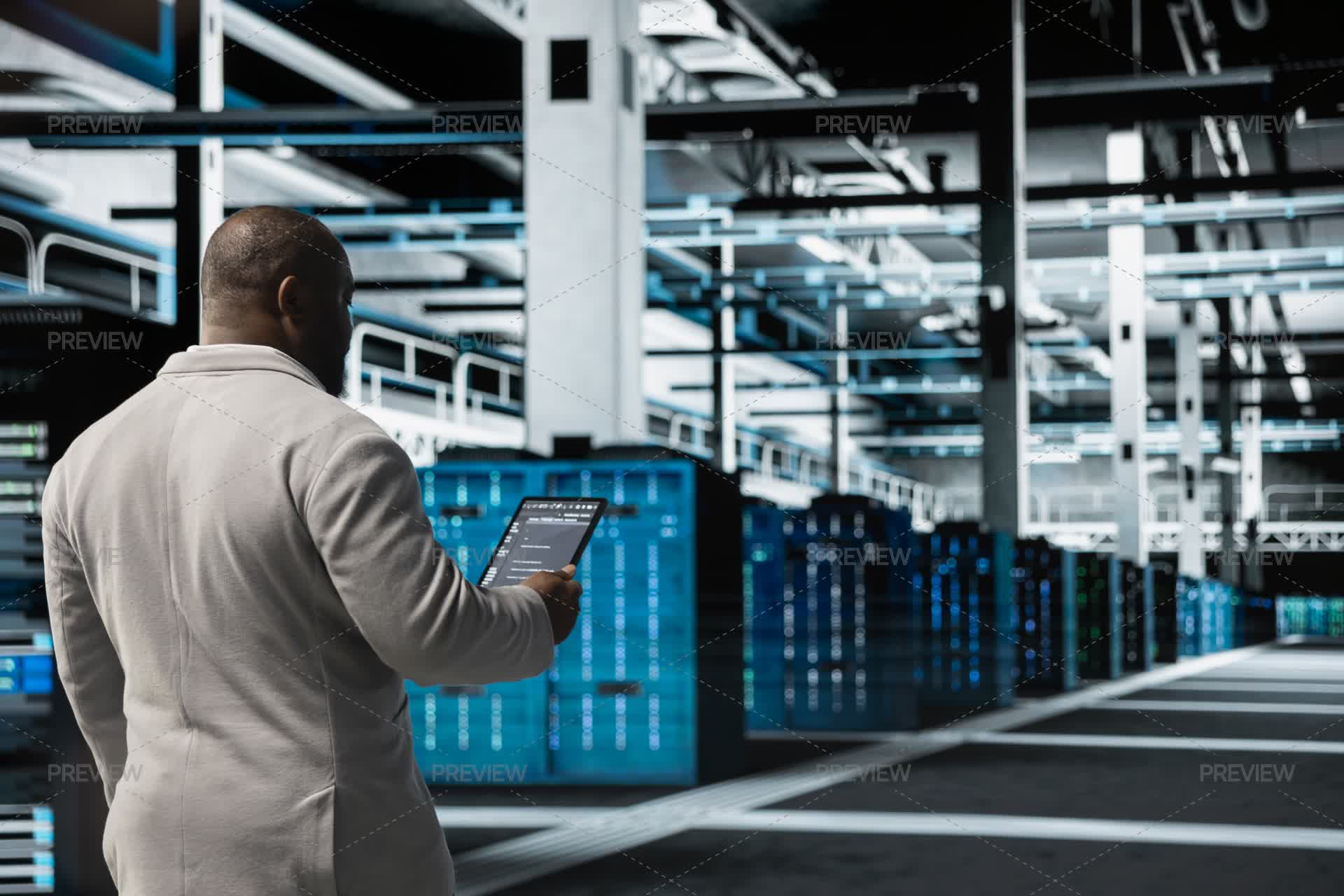 Technician Walking In Data Center Running Lines Of Code On Tablet ...