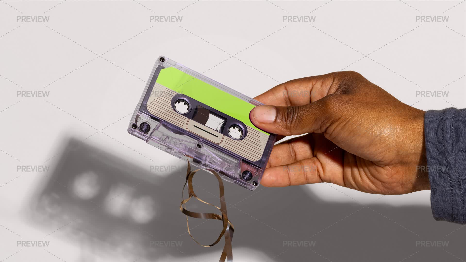 Hand Holding Cassette Tape - Graphics | Motion Array