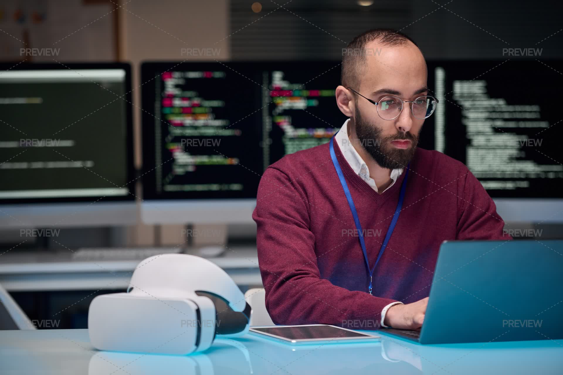 Computer Programmer Working At Workplace by Mediaphotos - Stock Photos ...