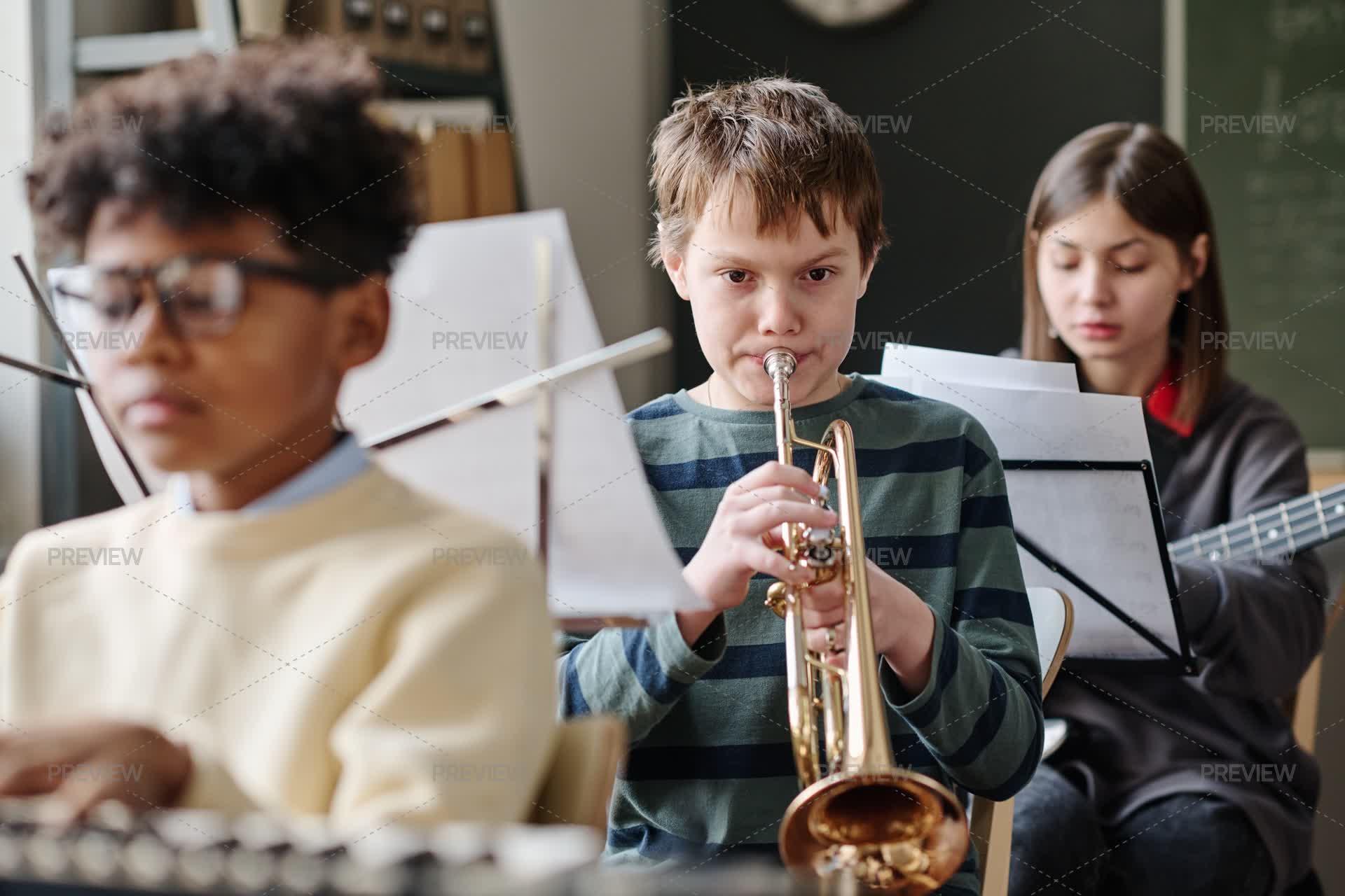 Trumpet Array Boy Playing Trumpet In School Orchestra - Stock Photos | Motion Array