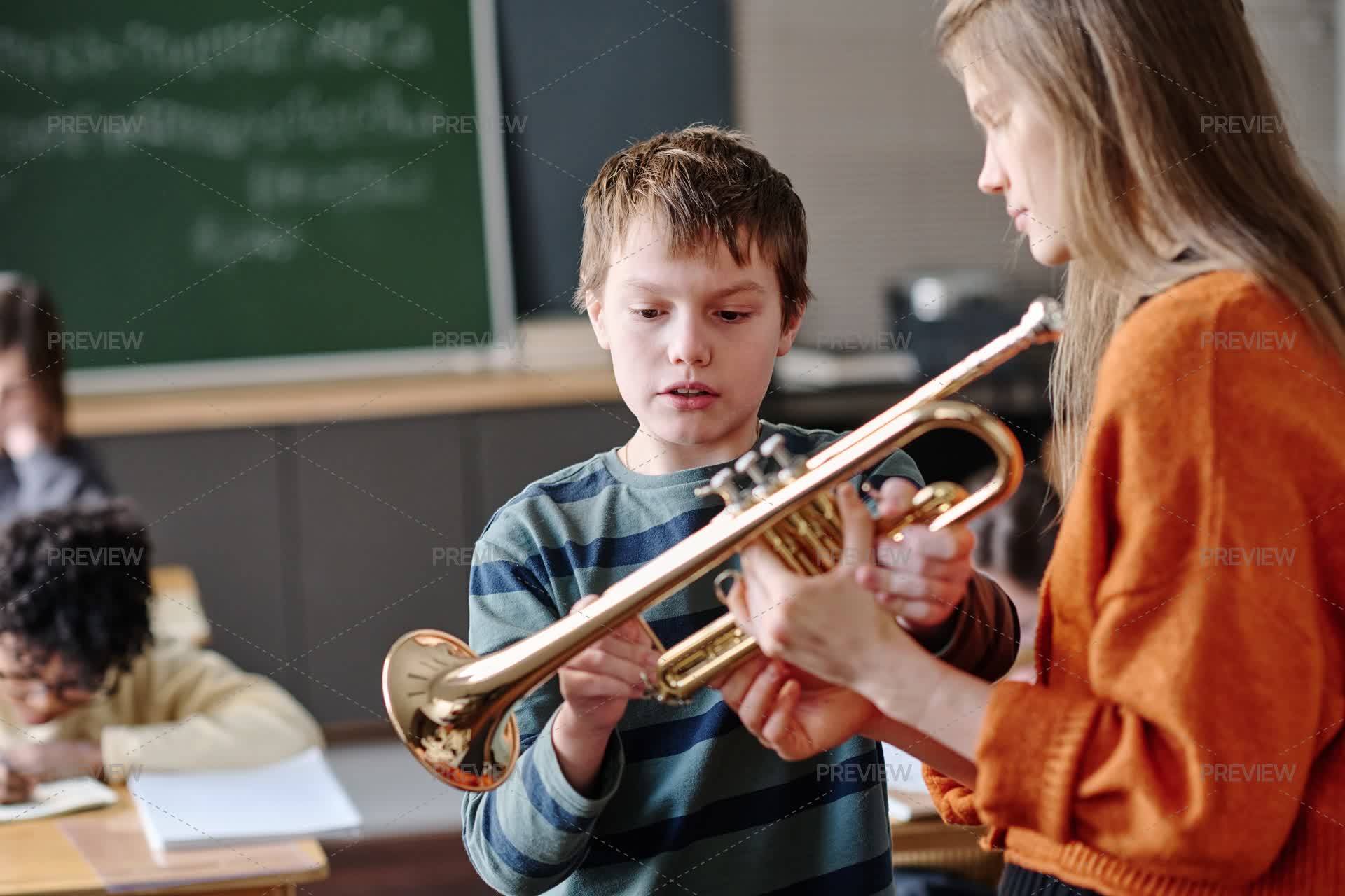Trumpet Array Music Teacher Giving Trumpet To Student - Stock Photos | Motion Array