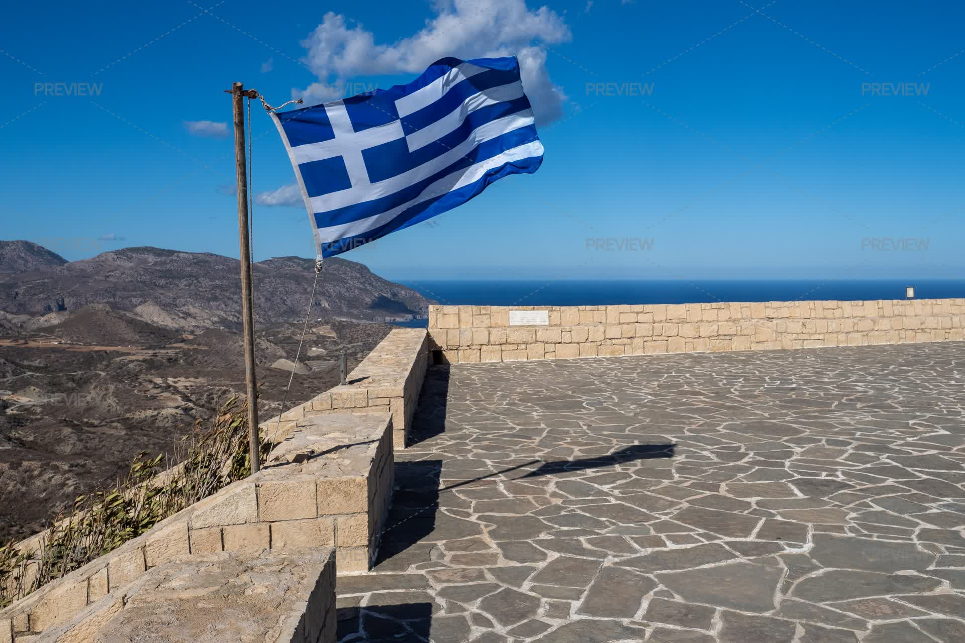 Flag Of Greece Waving On A Viewpoint Overlooking Mountains And Sea ...