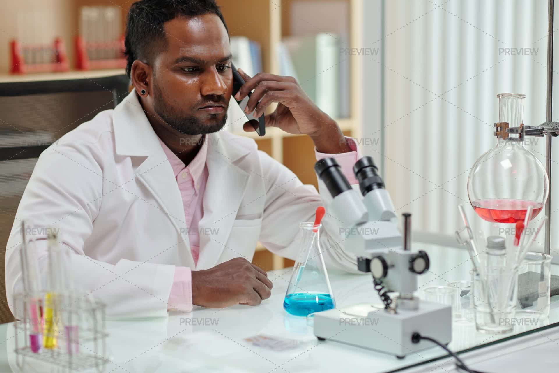 Medical Laboratory Worker Talking On Phone With Patient - Stock Photos ...