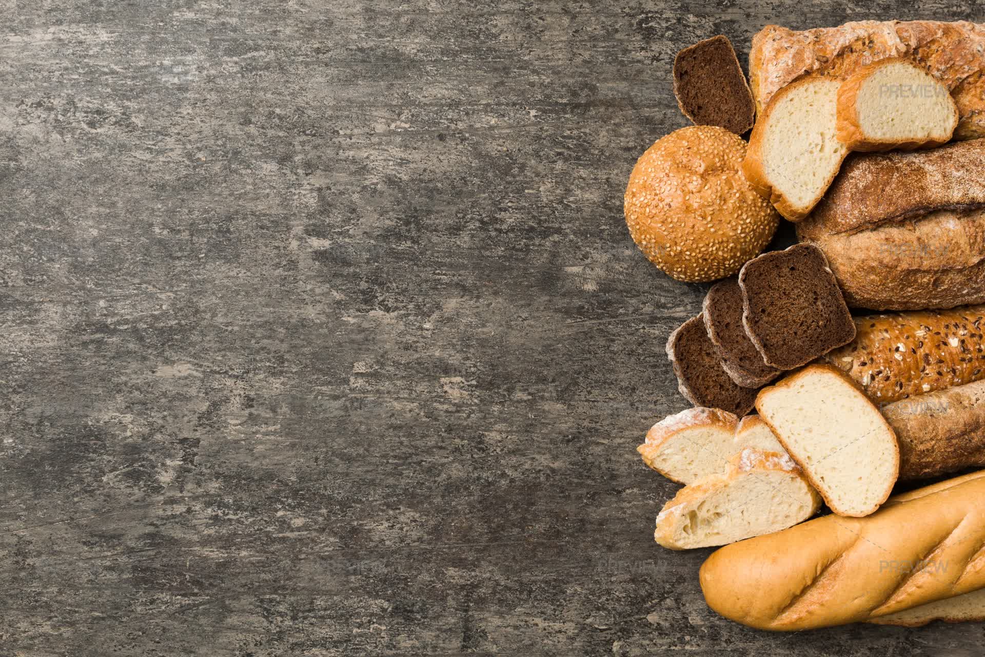 A Variety Of Different Types Of Bread And Baguettes On The Table ...