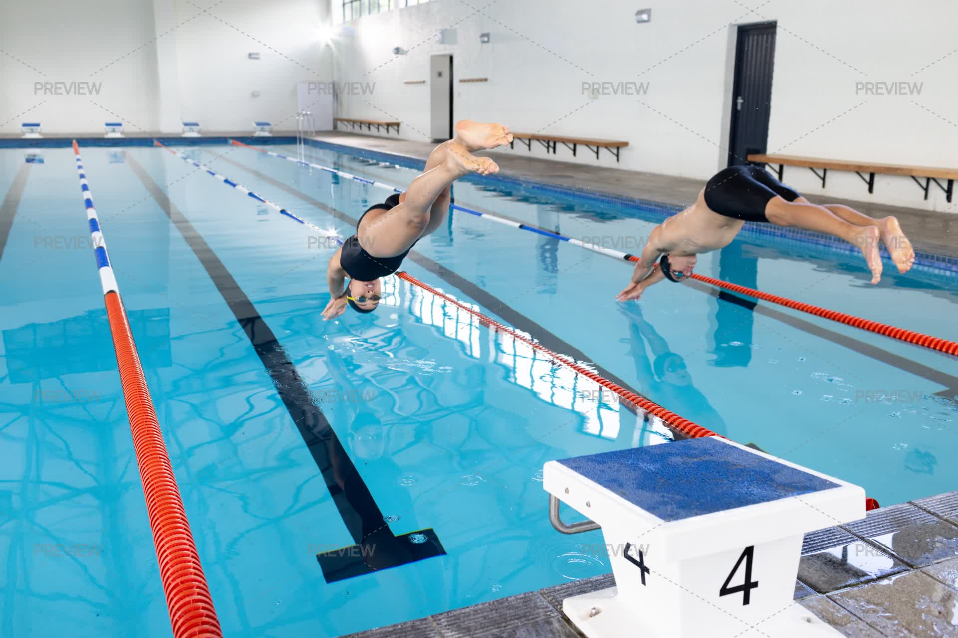 Diving Pool From Inside Swimmers Dive Into Indoor Pool by Wavebreak Media - Stock Photos ...