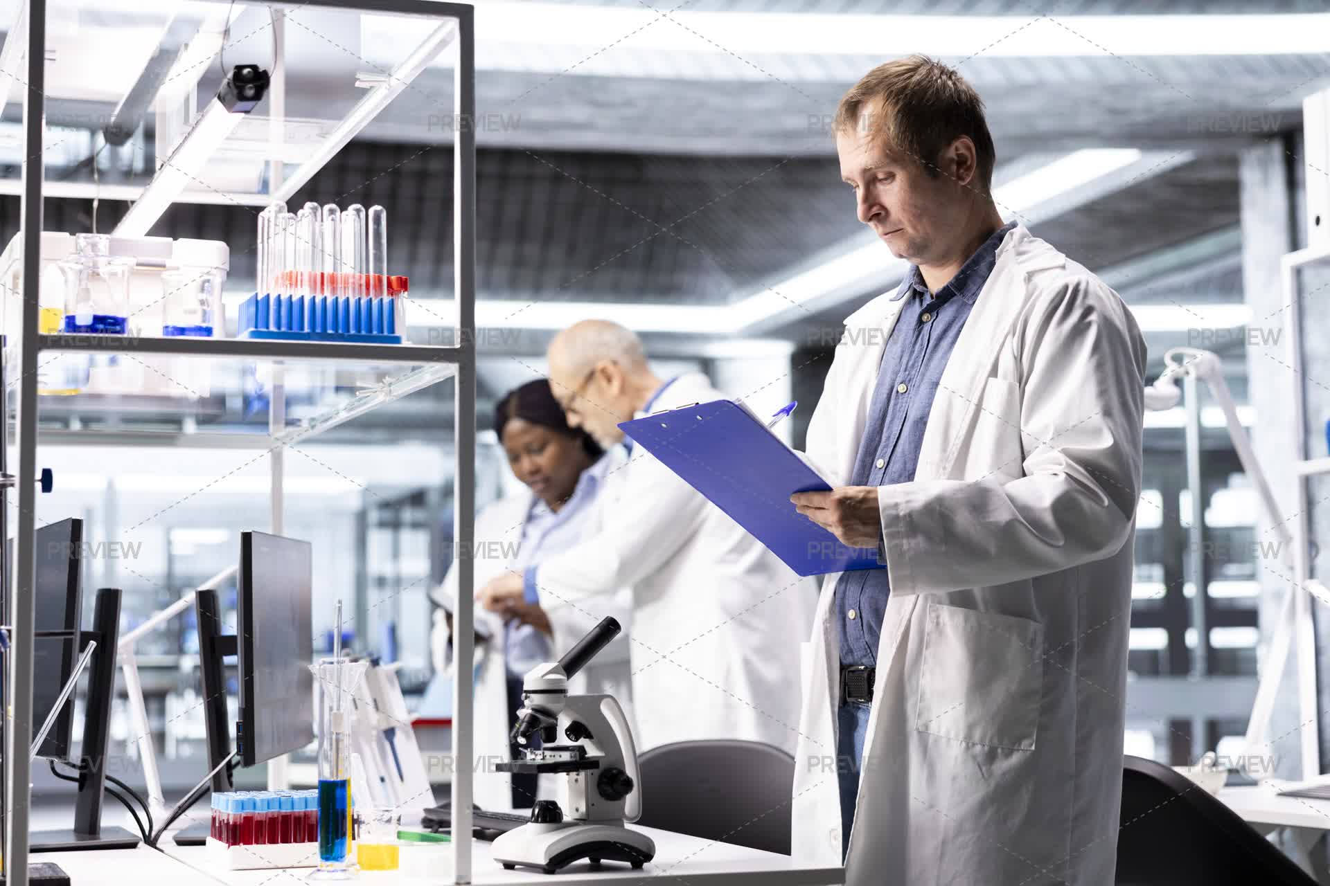 Expert Lab Male Scientific Expert Reviewing Samples In High Tech Laboratory ...