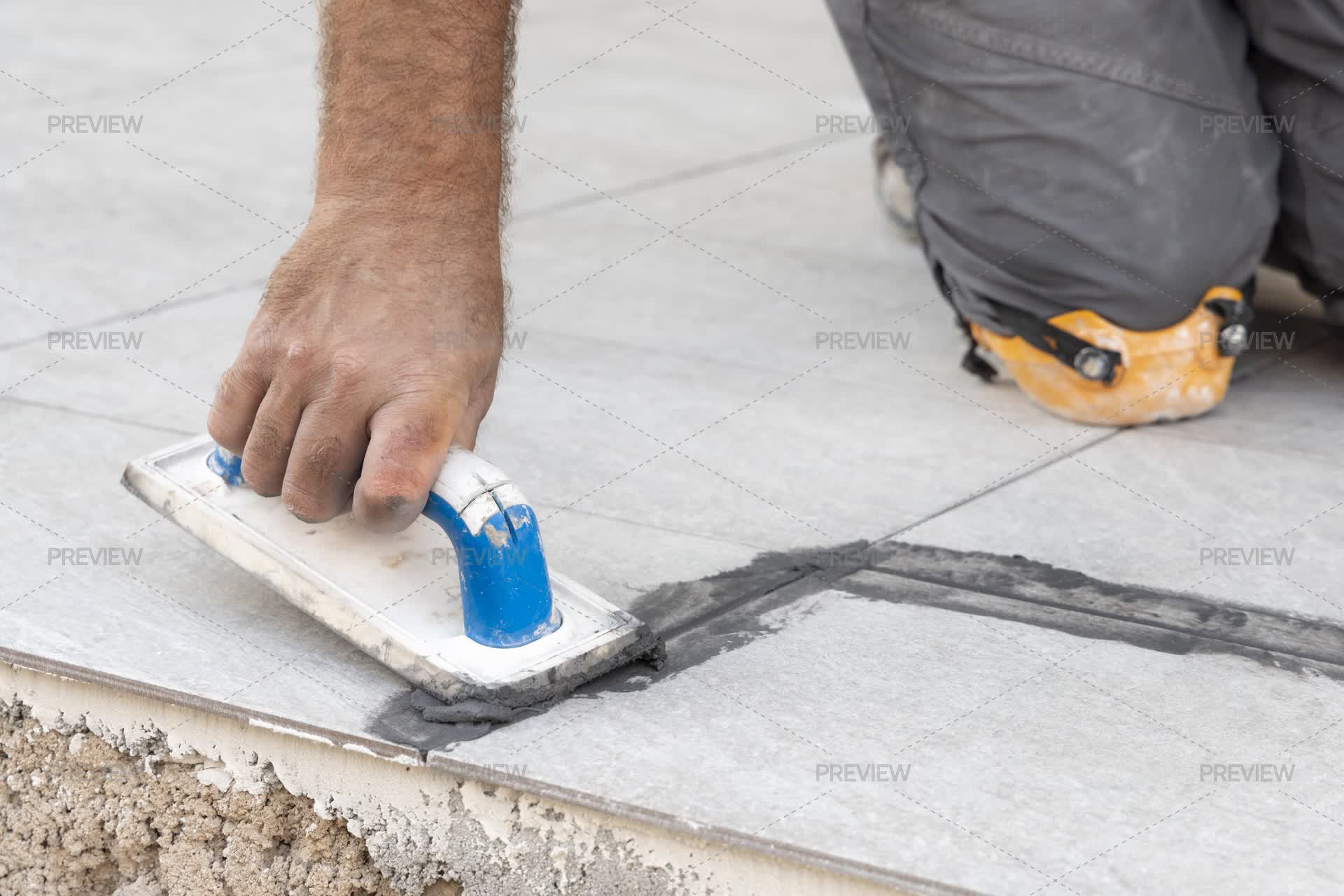 Array Grout Craftsman Filling Tile Joints With Grout Using A Float, Hand Closeup ...