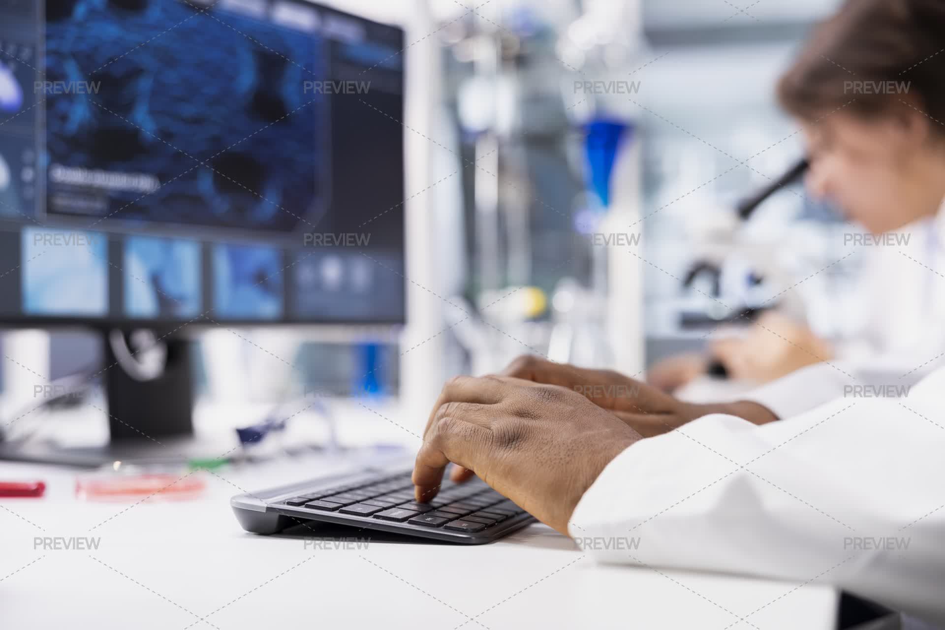 Close-Up Of Lab Technician Typing On PC Keyboard, Looking At 3D ...