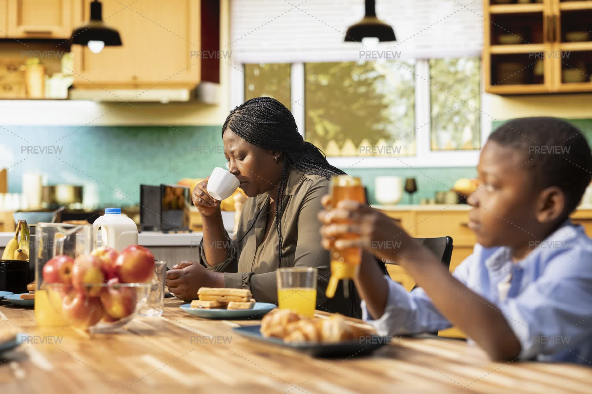 Family Sharing Croissants And Orange Juice In The Morning by DCStudio ...
