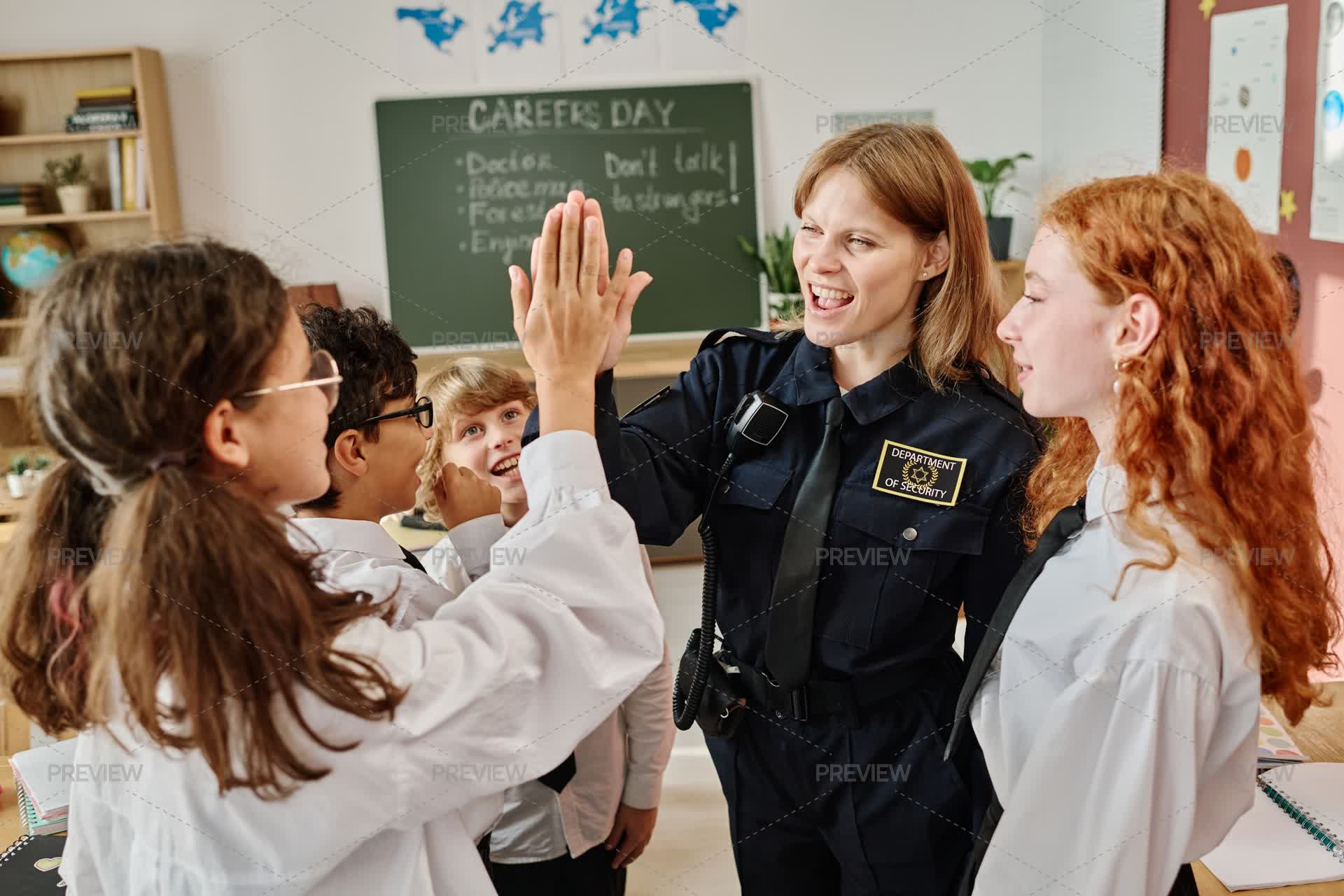 Police Officer Doing High Five With Kids - Stock Photos | Motion Array