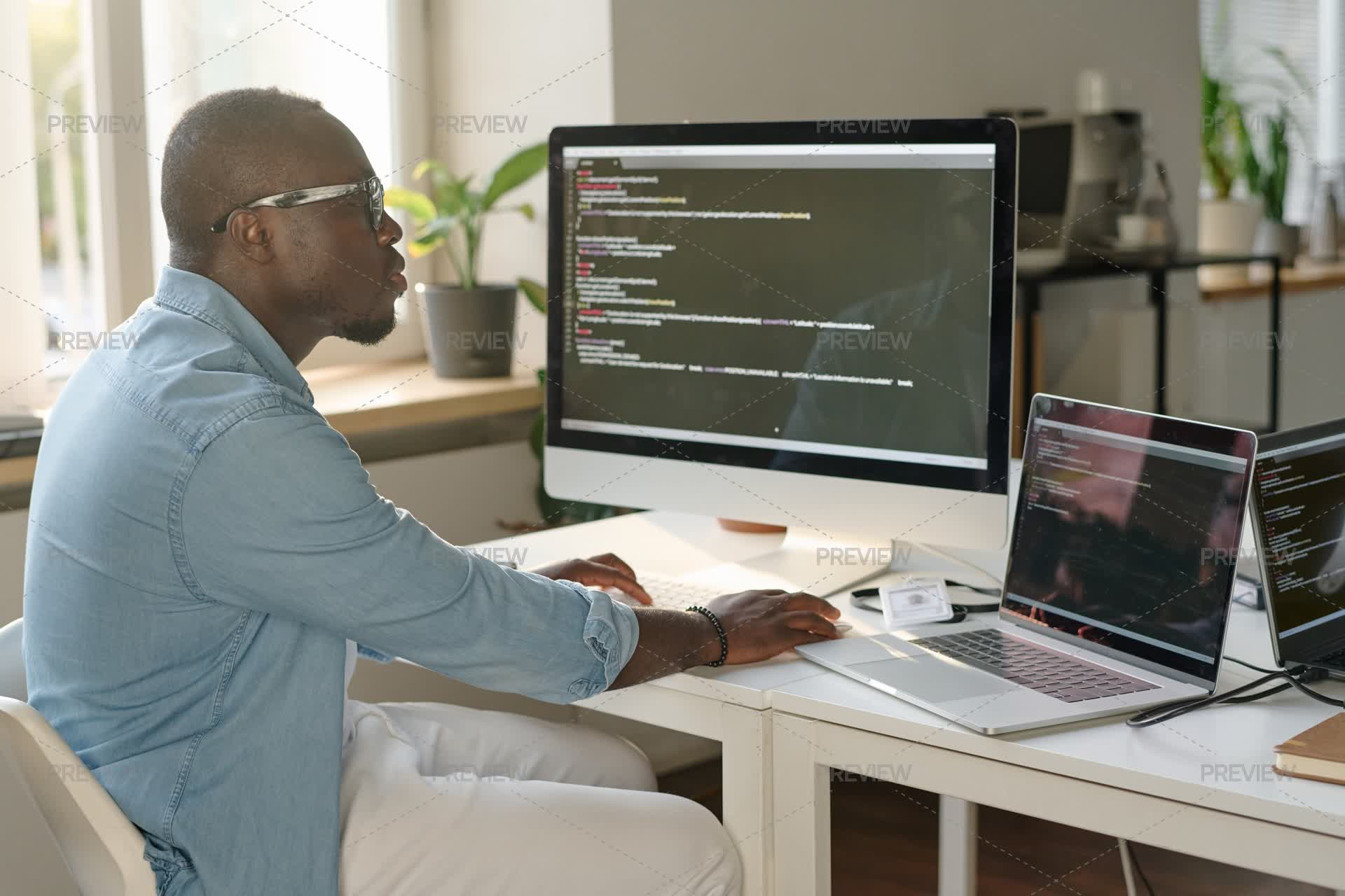 Man Coding At Table by AnnaStills - Stock Photos | Motion Array