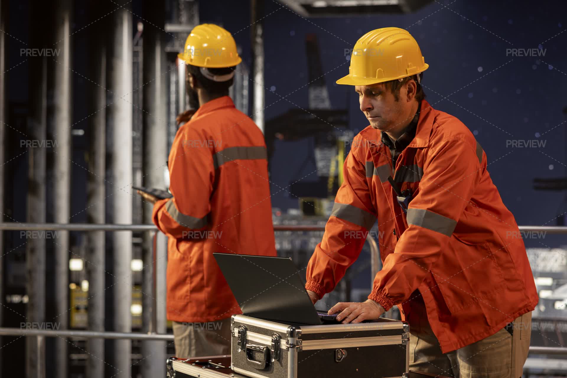 Environmental Officer Uses Laptop On Offshore Rig Under The Northern ...